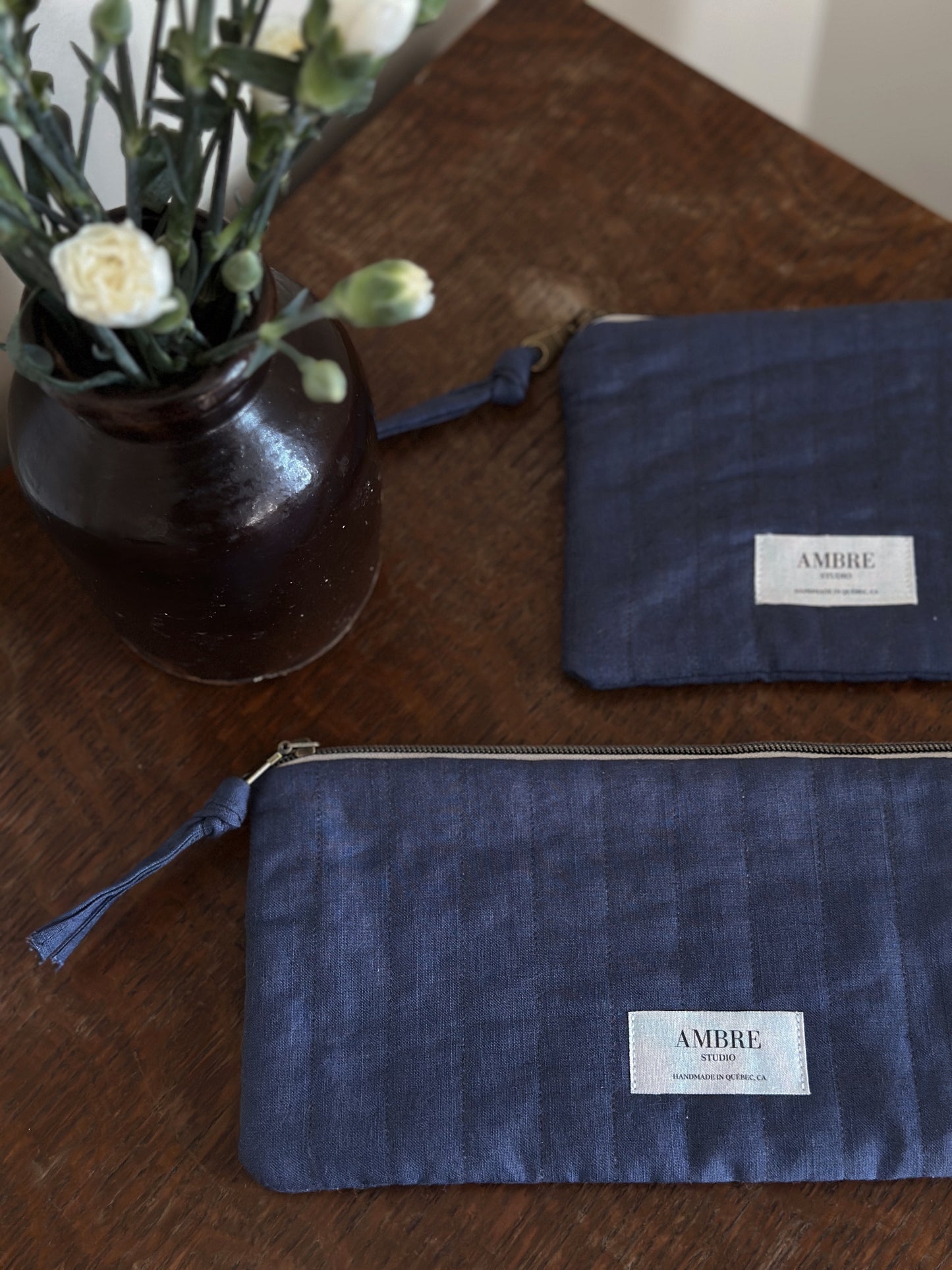 Duo of quilted navy linen pouches