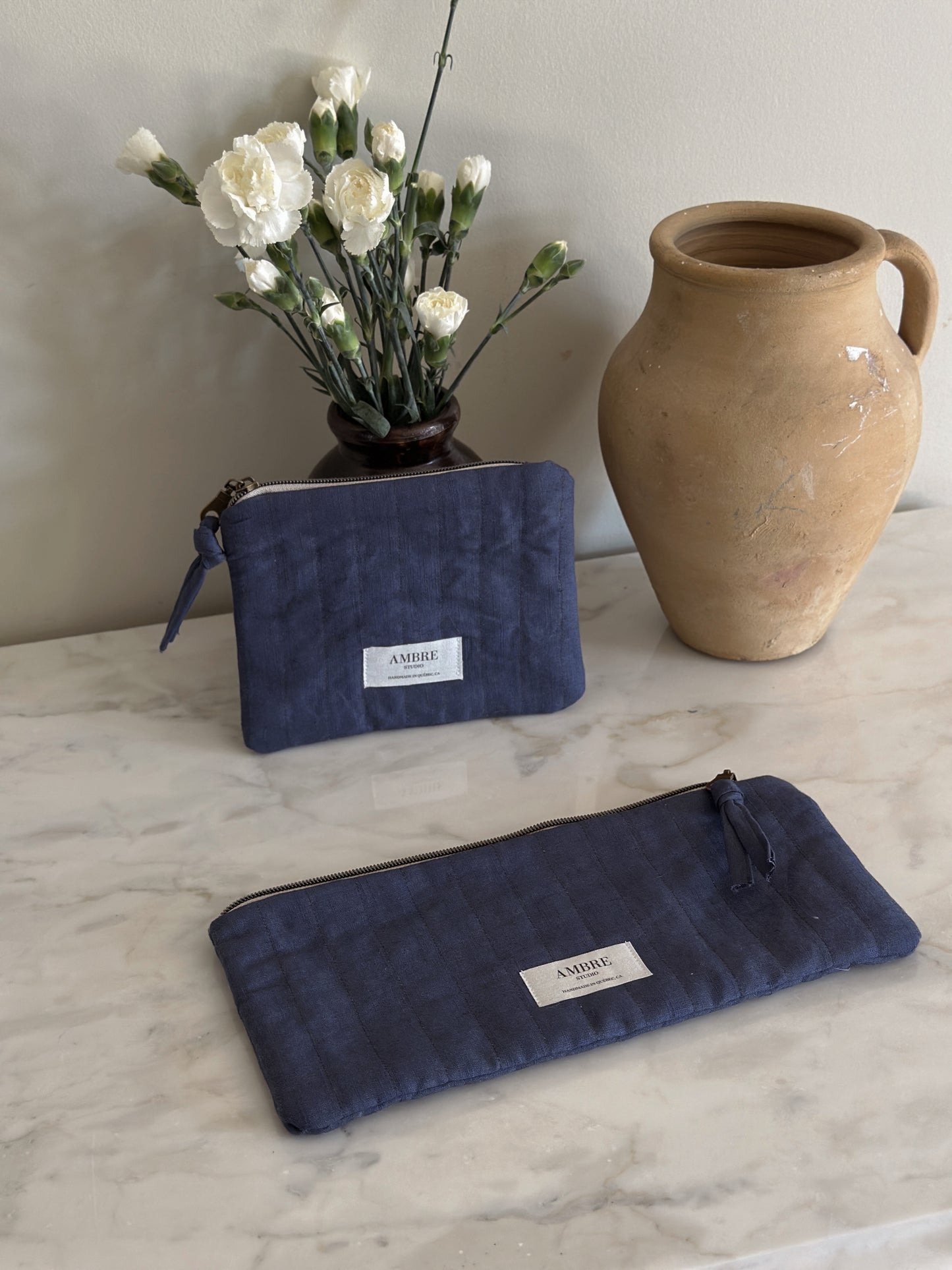 Duo of quilted navy linen pouches